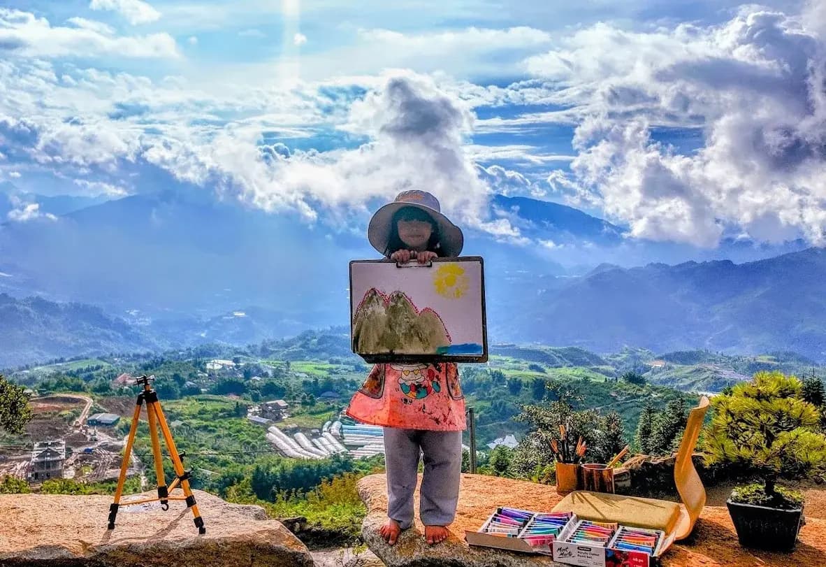 young artist Mia Mai painting in the Vietnamese mountains